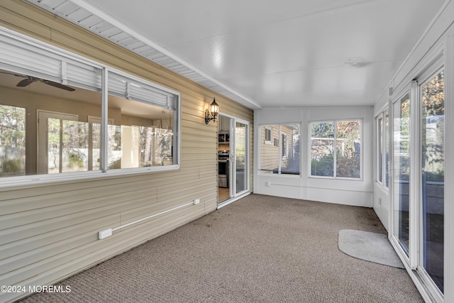 unfurnished sunroom with lofted ceiling