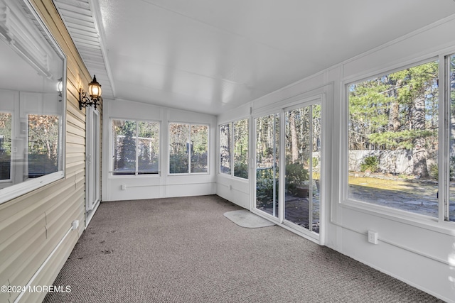 unfurnished sunroom featuring a healthy amount of sunlight and lofted ceiling