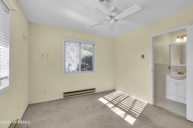 unfurnished bedroom with ceiling fan, light carpet, connected bathroom, and a baseboard radiator