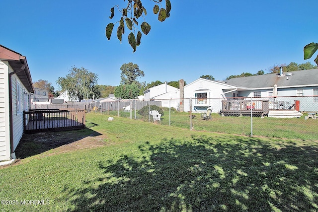 view of yard with a residential view, fence, and a deck