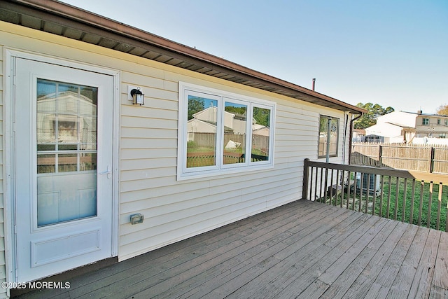 wooden terrace featuring fence