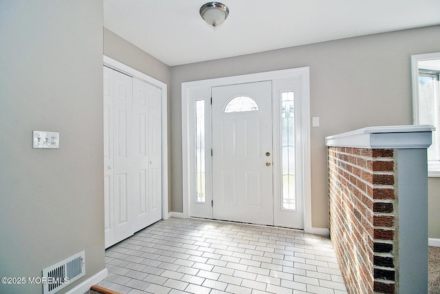 entrance foyer with visible vents, baseboards, and light tile patterned flooring