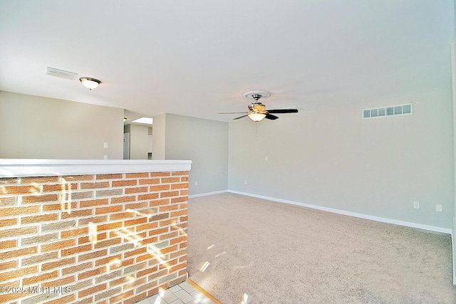 unfurnished room featuring a ceiling fan, carpet, visible vents, and baseboards