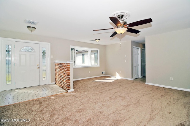 entryway featuring a ceiling fan, light carpet, visible vents, and baseboards