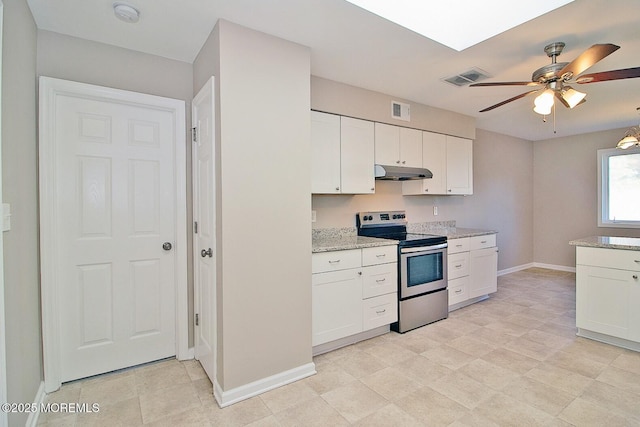 kitchen with under cabinet range hood, electric range, and white cabinetry