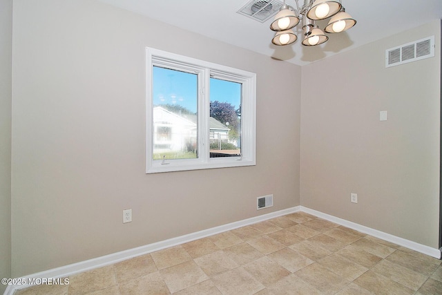 empty room featuring an inviting chandelier, baseboards, and visible vents