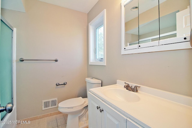 bathroom with tile patterned flooring, toilet, vanity, visible vents, and baseboards