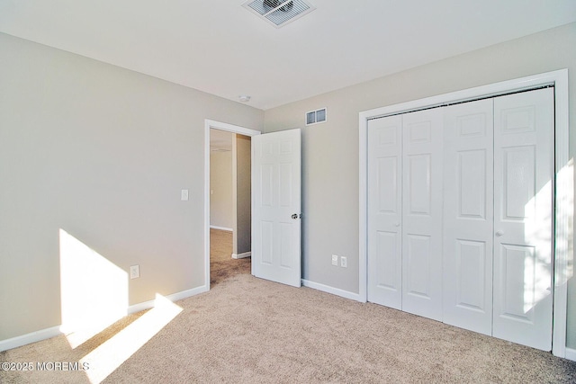 unfurnished bedroom with light carpet, baseboards, and visible vents