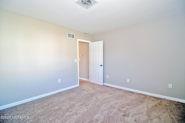 carpeted empty room with baseboards and visible vents