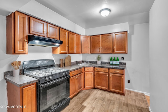 kitchen with light hardwood / wood-style floors, sink, and black gas range oven