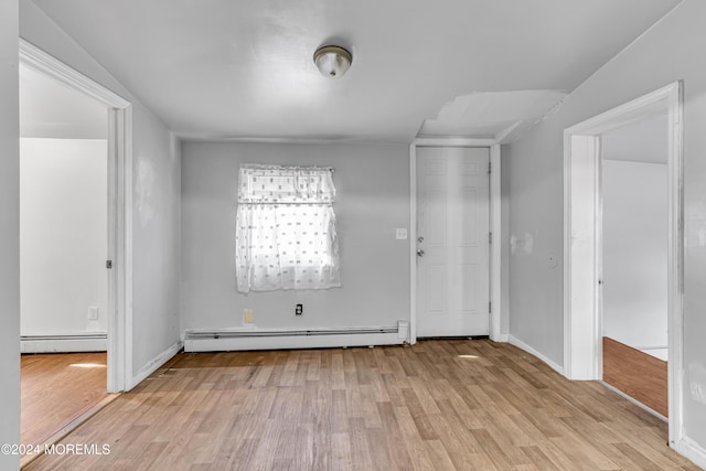 interior space featuring light wood-type flooring and a baseboard heating unit