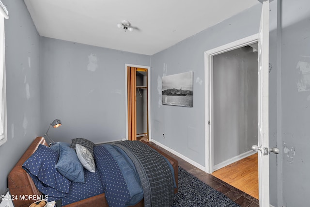 bedroom featuring dark hardwood / wood-style flooring and a closet