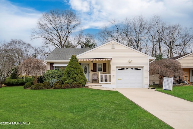 view of front of property with a front lawn, covered porch, and a garage