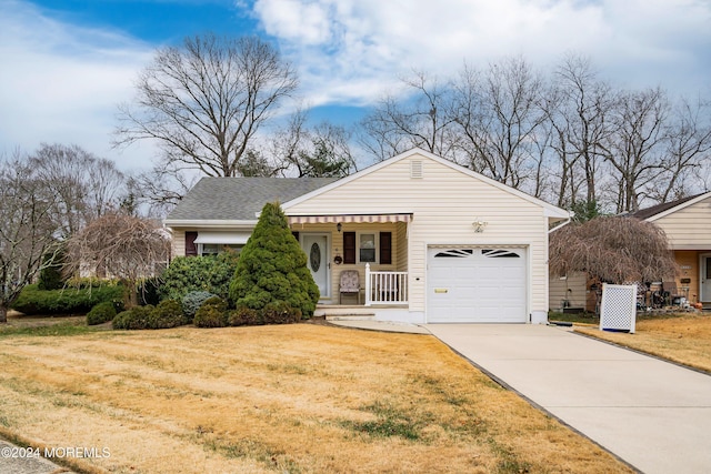 view of front of home with a porch, a garage, and a front lawn