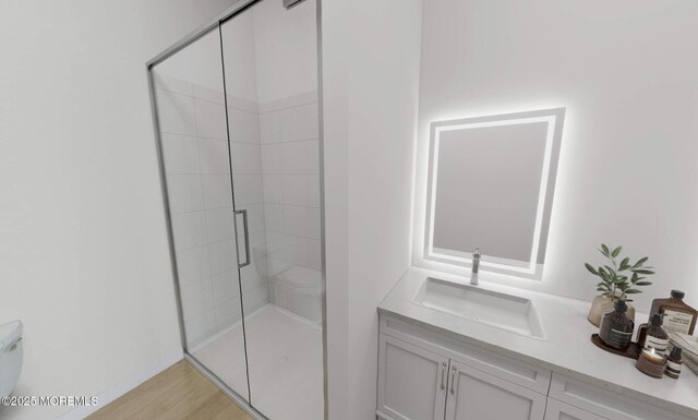 bathroom featuring an enclosed shower, vanity, toilet, and wood-type flooring