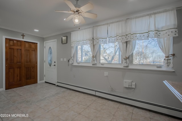 entryway with ceiling fan, plenty of natural light, ornamental molding, and a baseboard heating unit