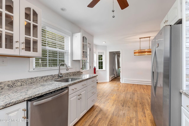 kitchen featuring light stone countertops, appliances with stainless steel finishes, sink, light hardwood / wood-style flooring, and white cabinets