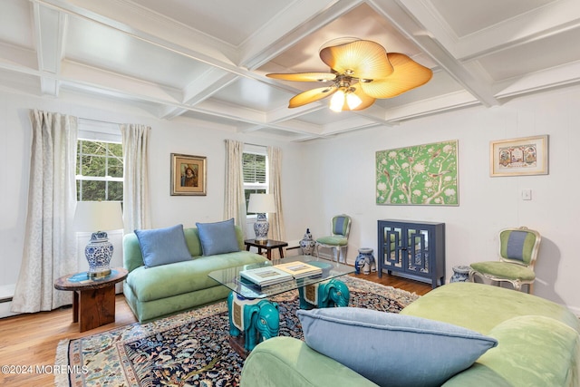 living room featuring a healthy amount of sunlight, wood-type flooring, beam ceiling, and coffered ceiling