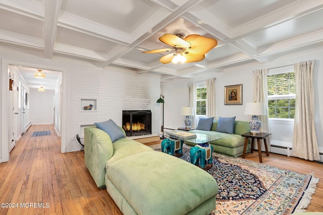 living room featuring beamed ceiling, light wood-type flooring, and coffered ceiling