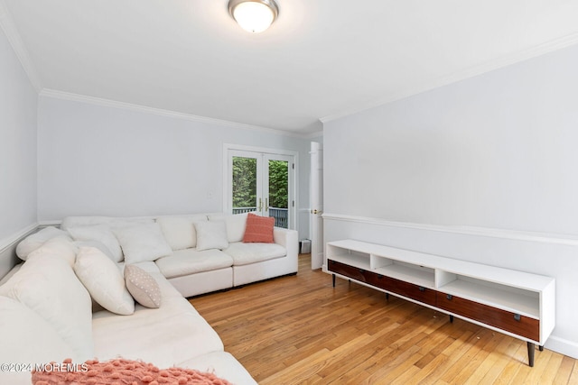 living room with wood-type flooring and ornamental molding