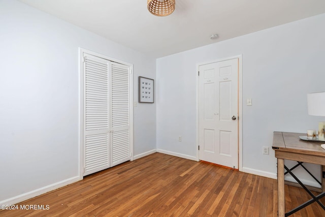 bedroom with hardwood / wood-style flooring and a closet