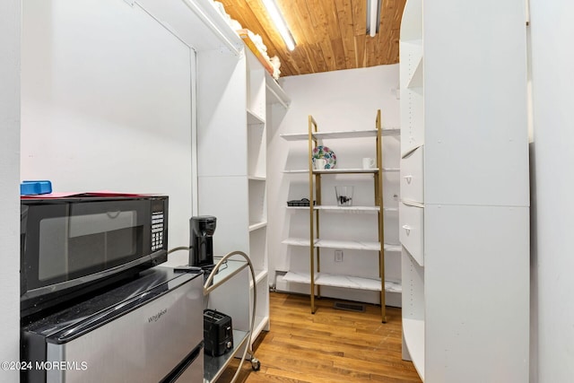 interior space featuring light wood-type flooring and wooden ceiling