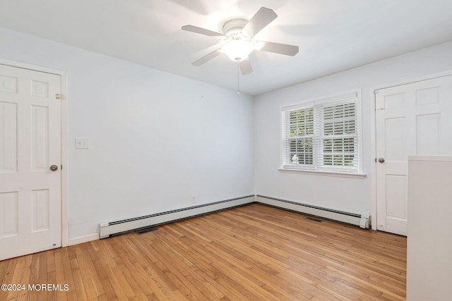 unfurnished room featuring ceiling fan, light hardwood / wood-style flooring, and a baseboard heating unit