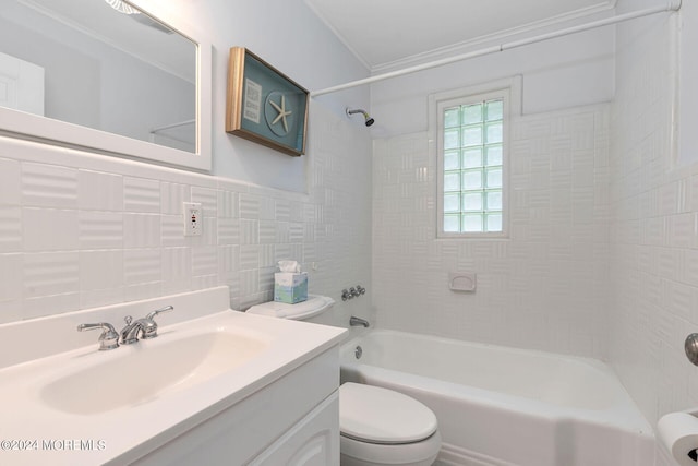 full bathroom featuring ornamental molding, toilet, vanity, tile walls, and tiled shower / bath