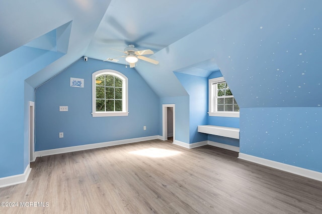 bonus room featuring light hardwood / wood-style floors, vaulted ceiling, and ceiling fan