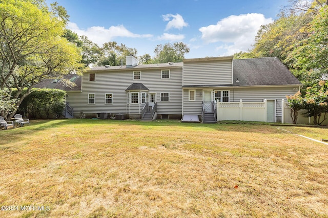 back of house with a lawn