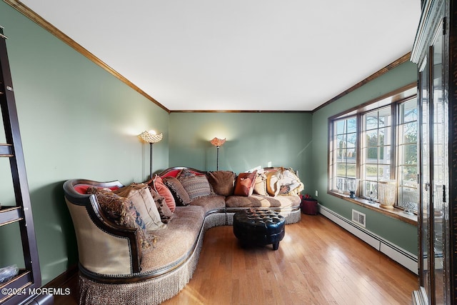 living room with baseboard heating, crown molding, and light hardwood / wood-style flooring