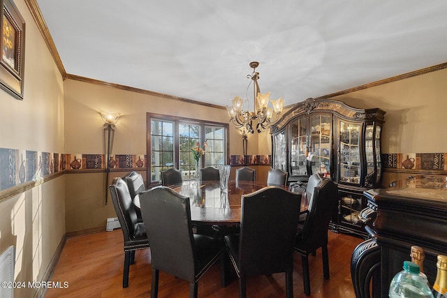 dining space with hardwood / wood-style floors, a chandelier, a baseboard radiator, and ornamental molding