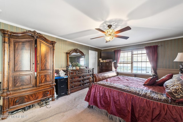 carpeted bedroom with ceiling fan and crown molding