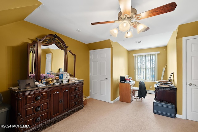 carpeted home office with vaulted ceiling, ceiling fan, and a baseboard heating unit