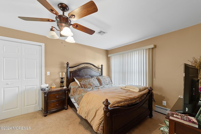 carpeted bedroom featuring ceiling fan, a baseboard heating unit, and a closet