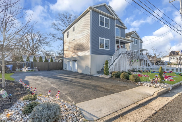 view of property exterior with a porch and a garage