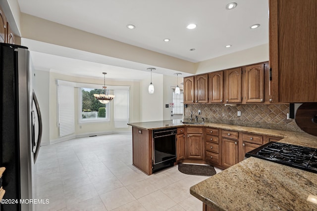 kitchen with pendant lighting, dishwasher, backsplash, stainless steel fridge, and kitchen peninsula