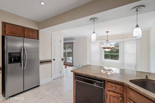 kitchen with stainless steel fridge with ice dispenser, hanging light fixtures, light stone countertops, and black dishwasher