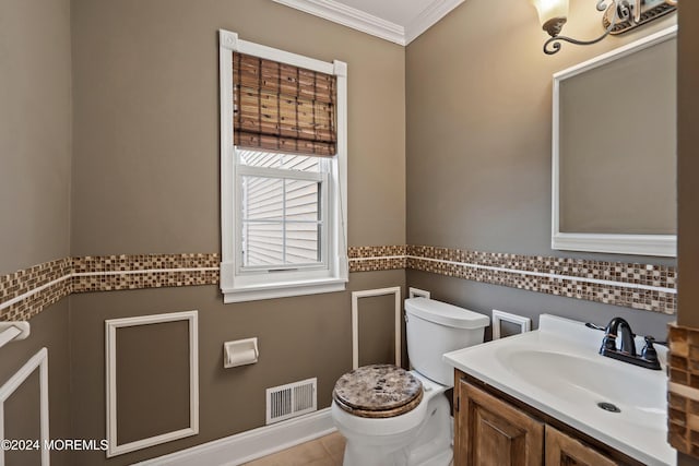 bathroom with tile patterned floors, vanity, toilet, and ornamental molding