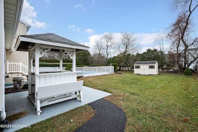 view of yard featuring a gazebo, a patio, a shed, and a pool