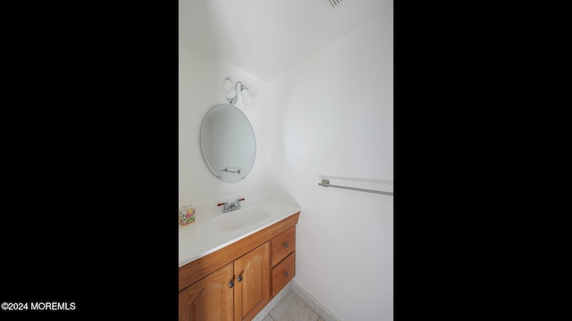 bathroom featuring tile patterned flooring, vanity, and lofted ceiling