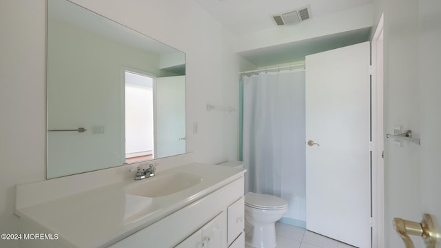 bathroom featuring toilet, vanity, tile patterned floors, and curtained shower