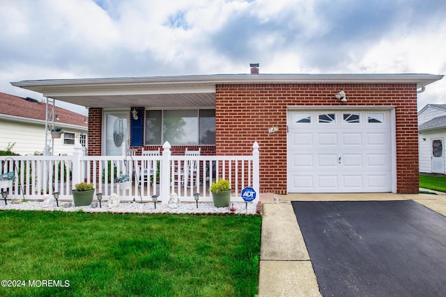 single story home with covered porch, a front yard, and a garage