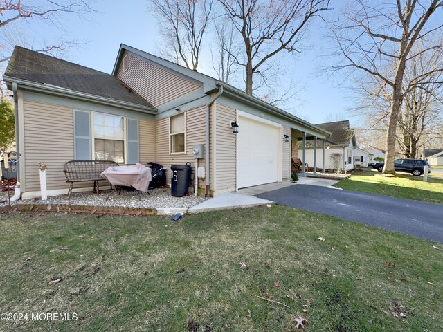 view of property exterior featuring a yard and a garage