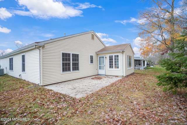 rear view of property featuring a sunroom, a patio area, and central AC