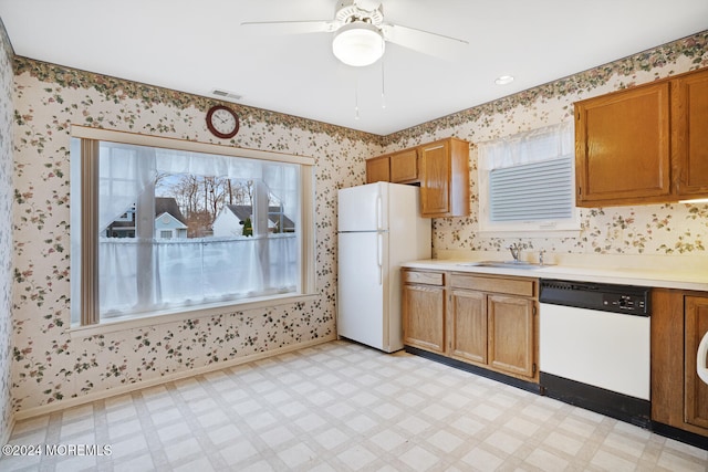 kitchen with white appliances, ceiling fan, and sink