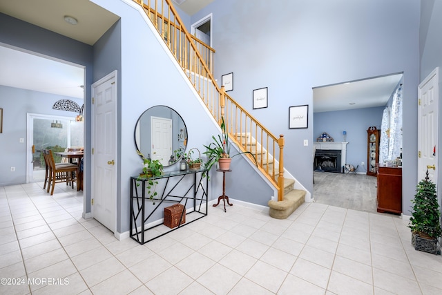 tiled entryway featuring a high ceiling