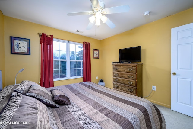 bedroom featuring ceiling fan and carpet