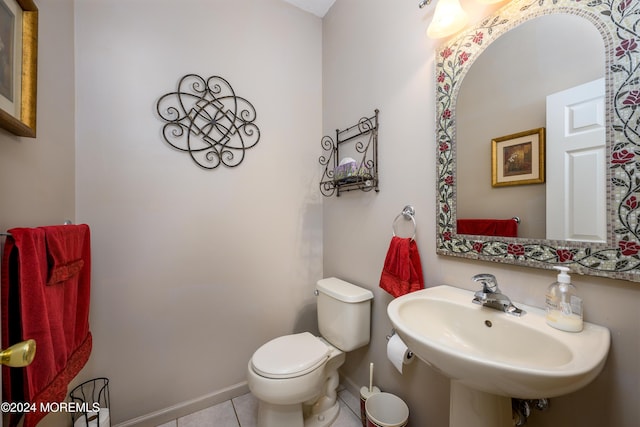 bathroom featuring toilet, tile patterned floors, and sink