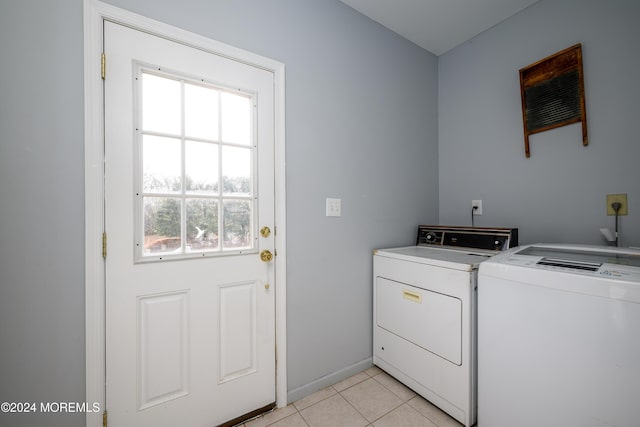 laundry room featuring independent washer and dryer and light tile patterned floors